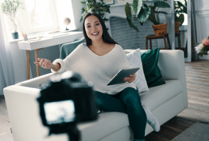 Image of a brand ambassador/influencer filming a product review on their couch