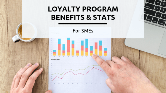 10 Loyalty Program Benefits & Stats for SMEs [2020 Ultimate Guide] - A person cutting a piece of paper - Business