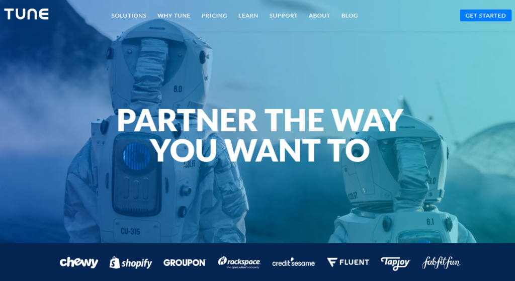 Screengrab of the Tune affiliate management software homepage. Image is of two astronauts facing away from the viewer. Text says "partner the way you want to".  