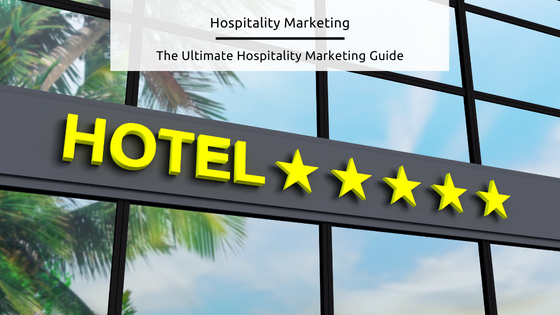 Hospitality Marketing - stock image of a sign that says 'hotel' in big yellow letters, with 5 yellow stars next to it, on the side of a modern glass wall